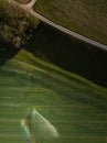 Aerial image of a lush green field being irrigated