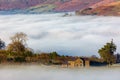 Farmland above low lying fog and a cloud inversion in the Brecon Beacons, Wales Royalty Free Stock Photo