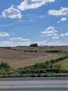 Farmland divided into fields looking up to the blue sky and it's white fluffy clouds Royalty Free Stock Photo