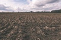 Farmland. Furrows on agricultural land - vintage film look