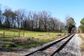 farmland gravel road crossing empty rural train tracks transportation railway countryside transport rails horizon Royalty Free Stock Photo