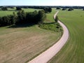 Farmland wirh white gravel road in spring, aerial view