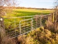 Farmland metal farm gate field closed locked agriculture nature
