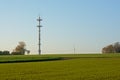Farmland with radio tower of an airport in the flemish countryside in warm evening light