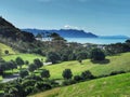 Farmland valley with rural road leading to a sea shore