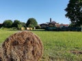 Farmlands in italy with haybales and church