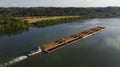 A River Barge carrying valuable goods travels down the Ohio River in the Eastern United States Royalty Free Stock Photo