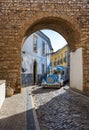 Faro, Algarve, Portugal- April 29, 2018: Tourist tram passing through the narrow winding street of the historical center of Faro