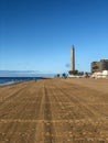 Faro Maspalomas with empty beach early in the morning