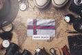 Faroe Islands Flag Between Traveler`s Accessories on Old Vintage Map. Overhead Shot Royalty Free Stock Photo