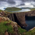 Faroe Islands landscape- Hike to the Traelanipa Slave Cliff near Leitisvatn Lake with steep drops into the ocean, Denmark Royalty Free Stock Photo