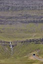 Faroe islands mountain tunnel entrance with waterfall. Denmark Royalty Free Stock Photo