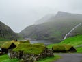 Nordic natural landscape, Saksun, Stremnoy island. Denmark. Iconic green roof houses. In the background valley and