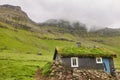 Faroe islands valley and traditional green roof house. Mikladalur, Kalsoy