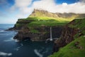 Faroe Islands waterfall Malafossu near village Gasadalurron the Island Vagar. Green mountain caost landscape Royalty Free Stock Photo