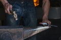 farrier making a traditional horseshoe on a forge