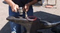 Farrier work: Shaping the hot horseshoe. Royalty Free Stock Photo