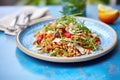 farro salad with sun-dried tomatoes on a blue plate