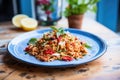 farro salad with sun-dried tomatoes on a blue plate