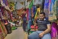 Iranian fabric seller smiles at tourists when waiting for buyers