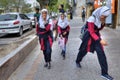 Cheerful Iranian schoolgirl in school uniform go home after school.