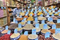 Spices, seeds and dried fruit, vendor standing next to showcase. Royalty Free Stock Photo