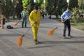 Three janitor sweeping road in city park of rest, Iran.