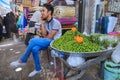 Young seller sells green plums an Vakil bazaar, Shiraz, Iran.