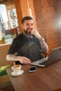 Faschionable man smiling sitting in coffee shop Royalty Free Stock Photo