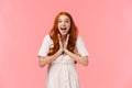 Fascinated, amused lucky redhead female in white dress, clap hands, applause from excitement and amazement, look camera