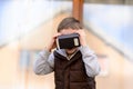 Fascinated little boy watching movie in VR virtual reality goggles