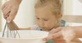 Fascinated little girl learning to bake