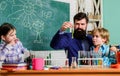 Fascinating chemical reaction. Teacher and pupils test tubes in classroom. Interesting school classes. School education
