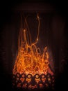 Fascinating spectacle of the bizarre magical dance of sparks and fire in the fireplace insert Royalty Free Stock Photo