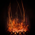 Fascinating spectacle of the bizarre magical dance of sparks and fire in the fireplace insert Royalty Free Stock Photo