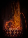 Fascinating spectacle of the bizarre magical dance of sparks and fire in the fireplace insert Royalty Free Stock Photo