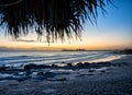 Fascinating sunset on a seashore seen through a thatch