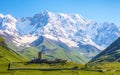 A fascinating view on Ushguli village at the foot of snow-capped Mt. Shkhara. Royalty Free Stock Photo