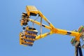 Amusement on funfair pendulum ride, fast spinning fairground amusement, moving wing on fairground Royalty Free Stock Photo