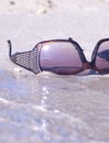 Fashinable sunglasses on the sand Royalty Free Stock Photo