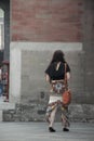 Fashinable young lady walking away from camera