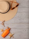 Fashion accessories - hat, orange glasses and sunscreen on a wo Royalty Free Stock Photo