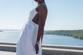 Fashion african black girl in a white dress, model posing on a background of blue sky. Young african american girl model in white Royalty Free Stock Photo