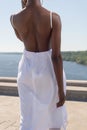 Fashion african black girl in a white dress, model posing on a background of blue sky. Young african american girl model in white Royalty Free Stock Photo