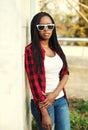 Fashion african woman wearing a red checkered shirt and sunglasses Royalty Free Stock Photo