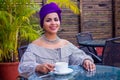 Fashion afro american girl with ethnic turban on head culture coffeebreak at summer tropical cafe . indian woman Royalty Free Stock Photo