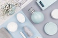 Fashion art cosmetics flat lay of different cosmetics products and accessories of silver, pastel blue, grey and white color.