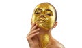 Fashion art Golden skin Woman face portrait closeup. Model girl with cracked gold foil on skin. Glamour shiny professional makeup