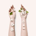 Fashion art hand woman in summer time and flowers on her hand with bright contrasting makeup. Creative beauty photo hand girls Royalty Free Stock Photo