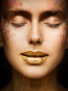 Fashion Art Makeup, Creative Beauty Face Lips Make Up, Gold Lipstick Closed Eyes in Color Dust Paint Royalty Free Stock Photo